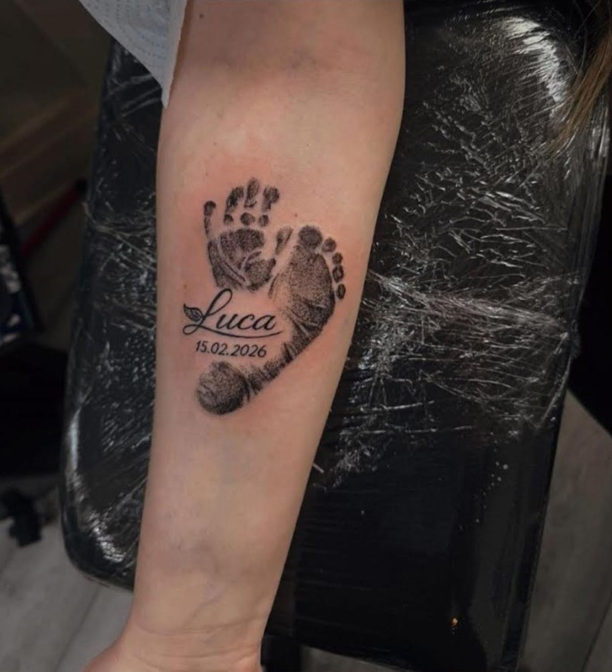 Megan's tattoo of Luca's hand and foot print