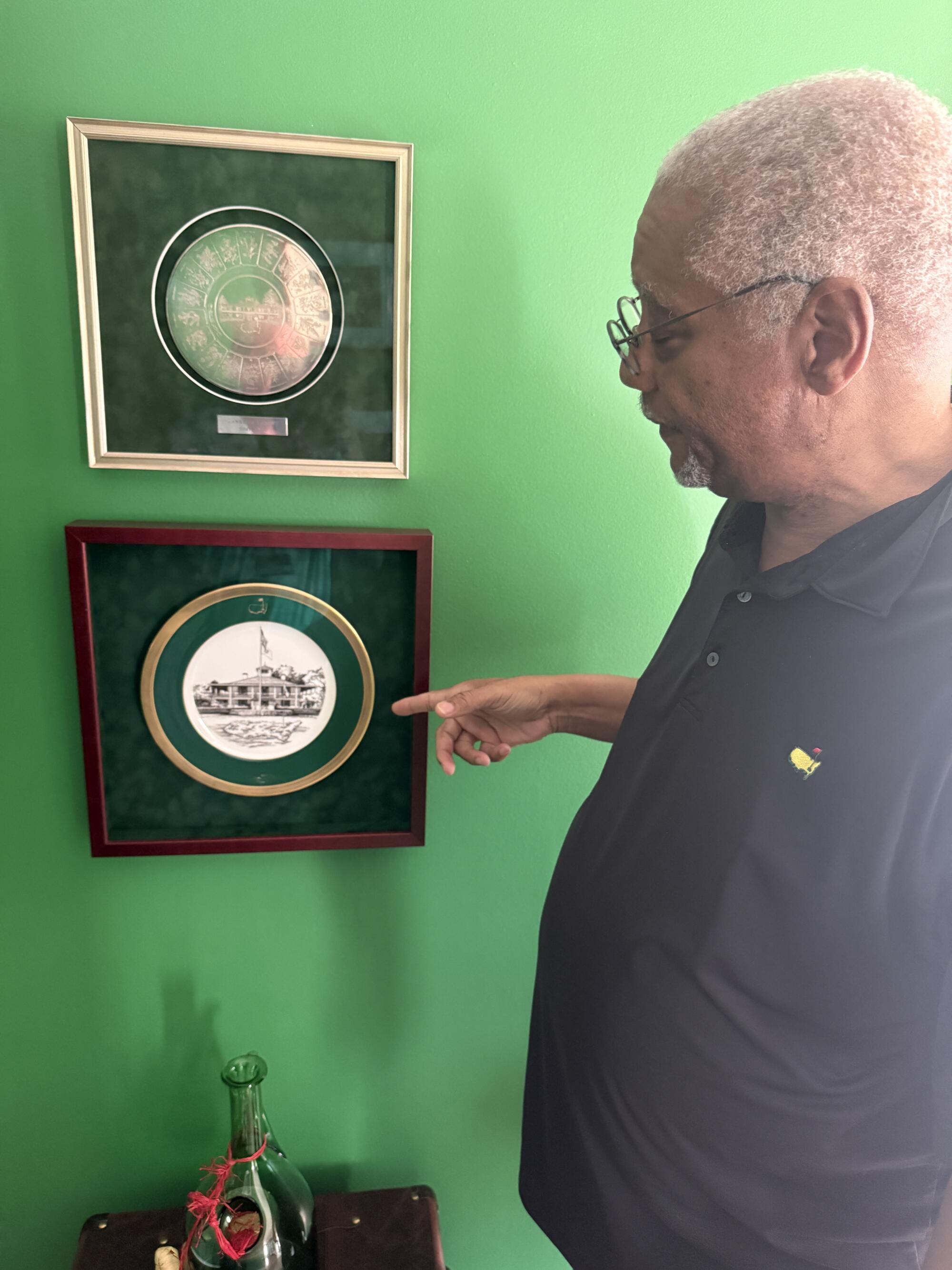 Lawrence Bennett, longtime chauffeur at Augusta National, shows some Augusta National keepsakes at his home.
