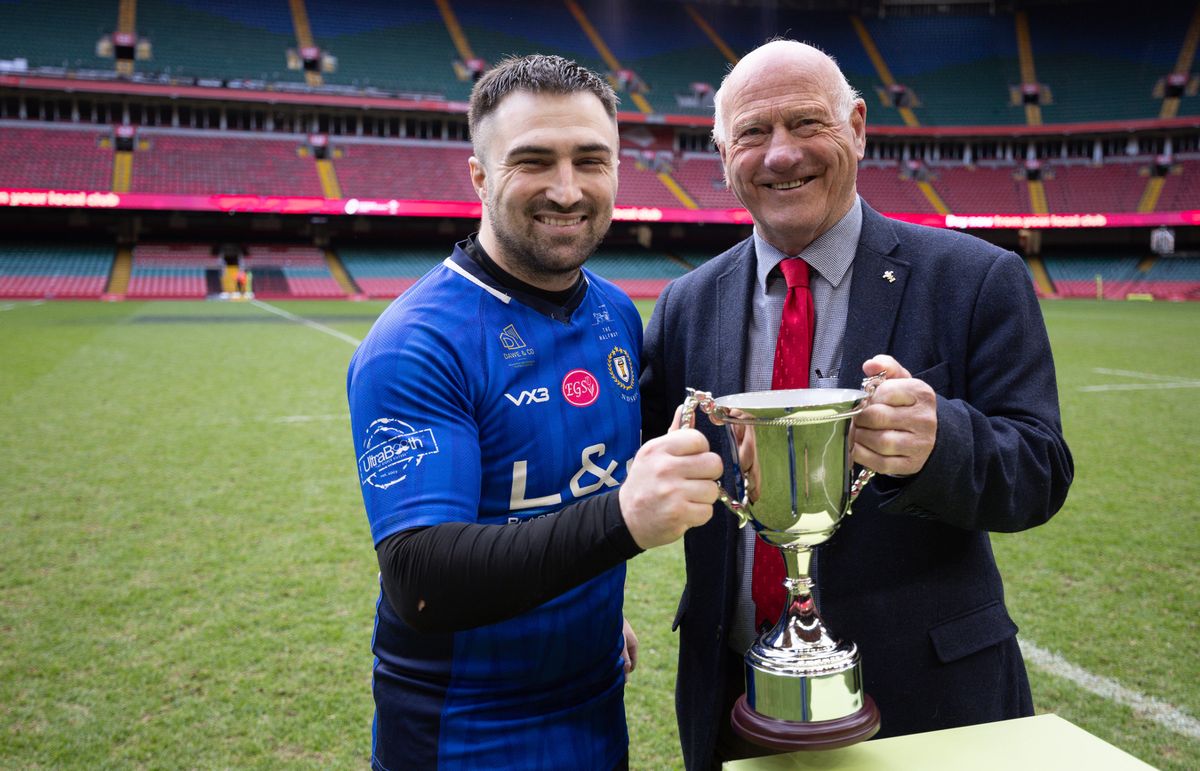 New Dock Stars Captain Jordan Williams receives the trophy from WRU President Terry Cobner