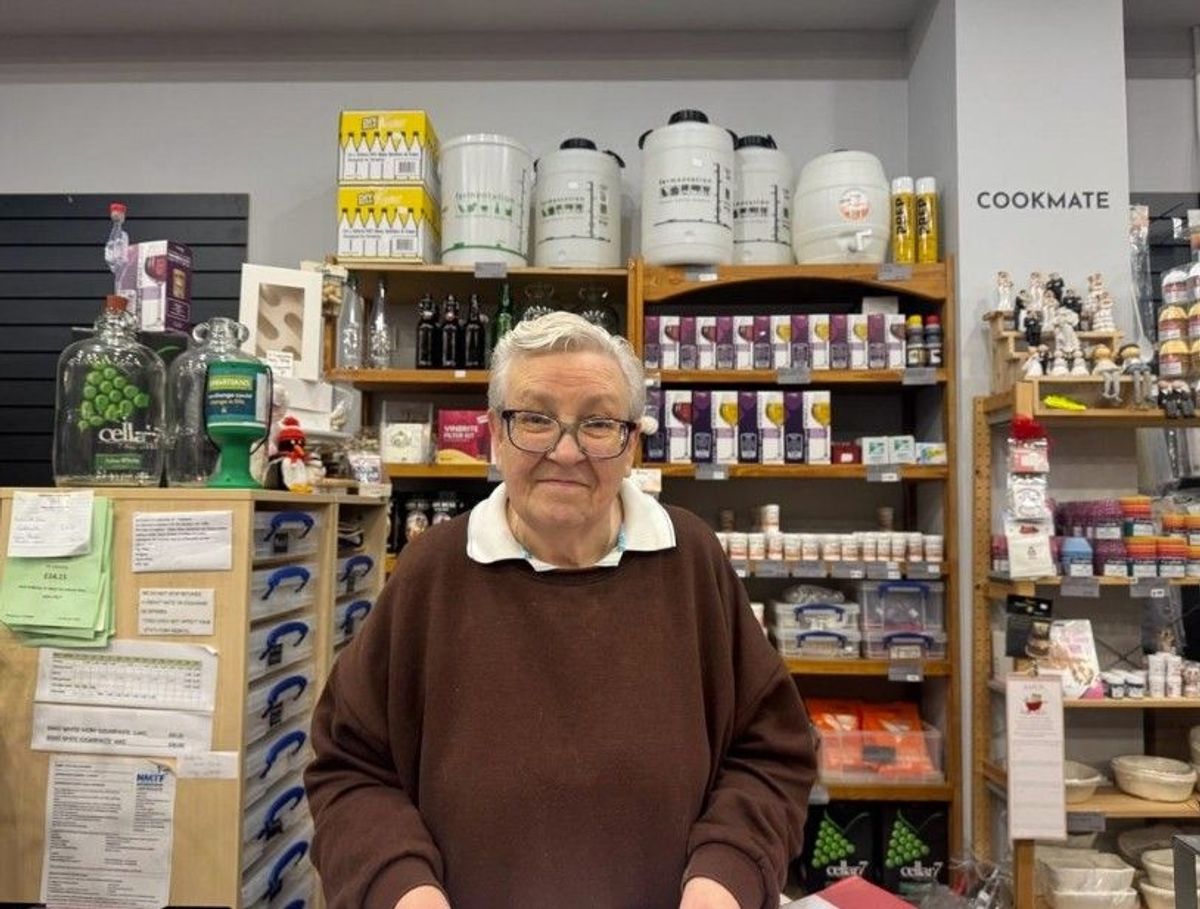 The image shows the pensioner behind the till