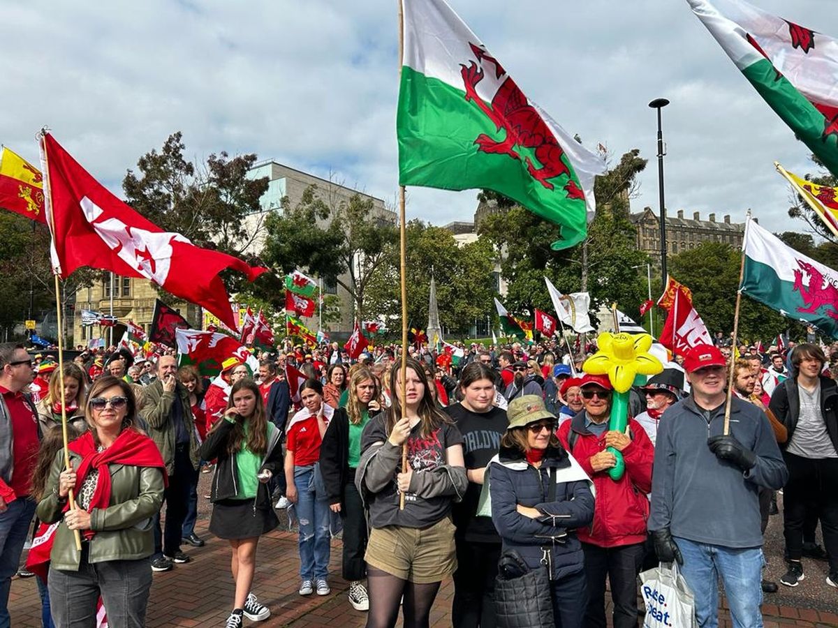 File image of marchers in Bangor waving Welsh flags