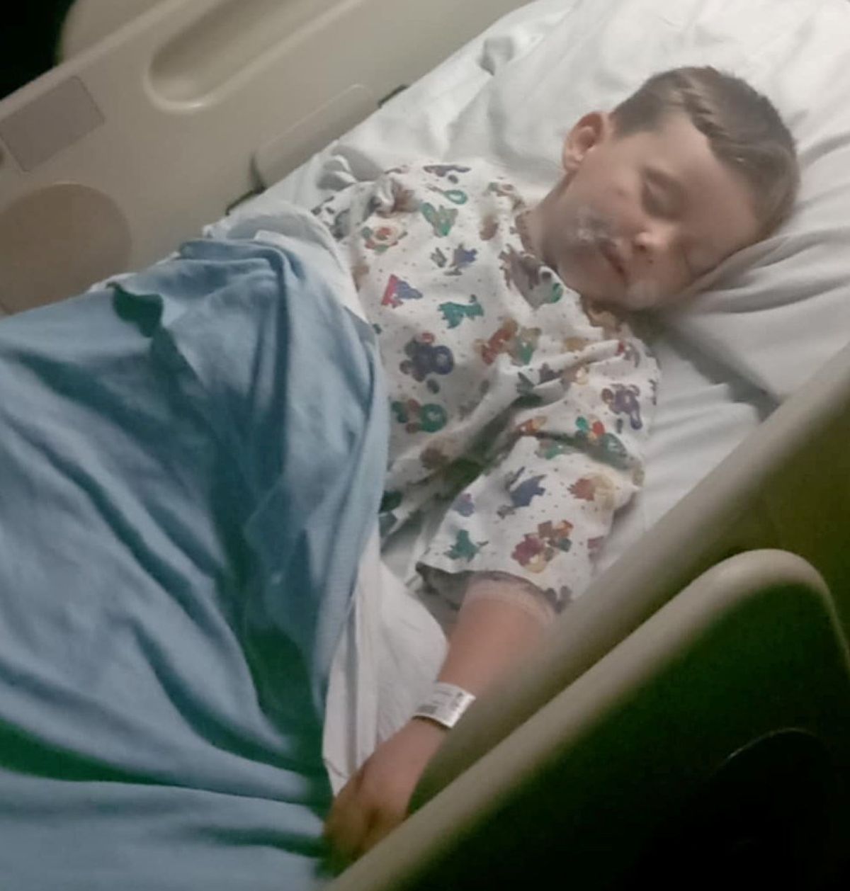 Antonio Quinn lying in hospital bed