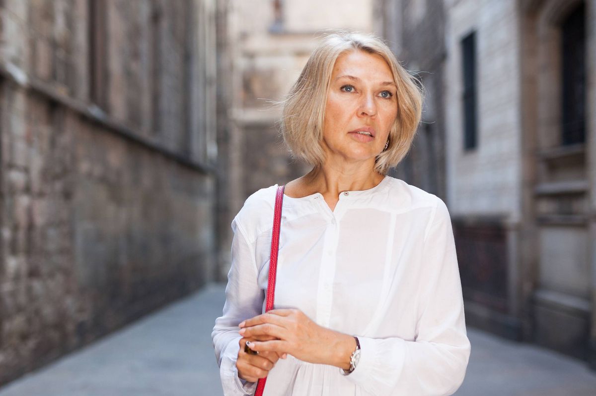 A woman walking on the street of an old city
