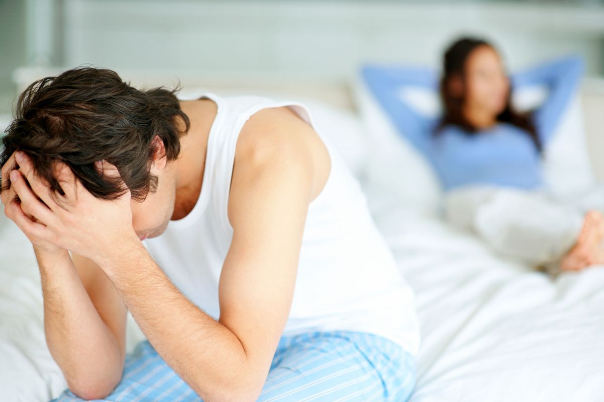 Portrait of a upset couple sitting on the bed after having a conflict