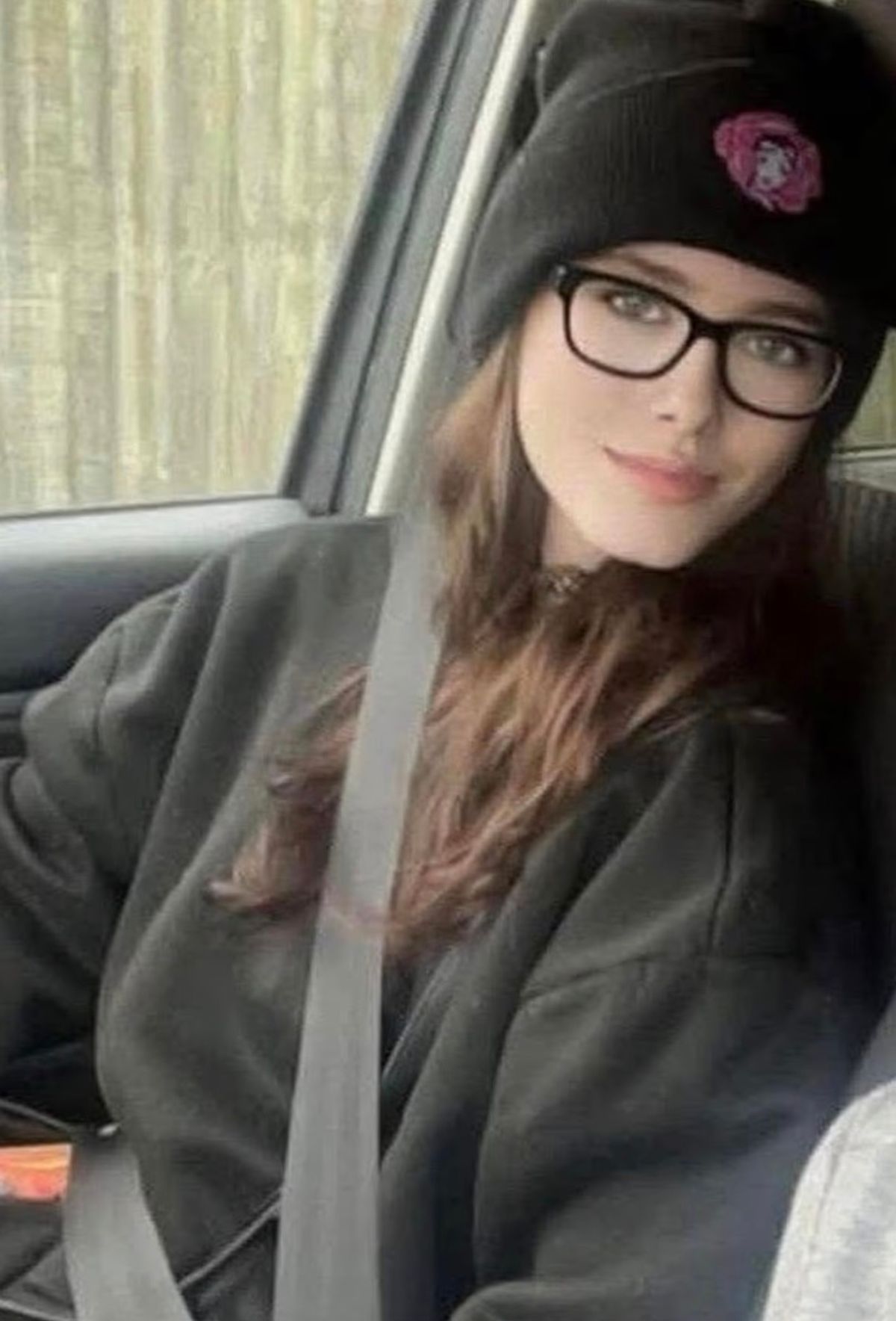 Jamie-Lea Biscoe wearing a black hoodie, black beanie hat and black glasses