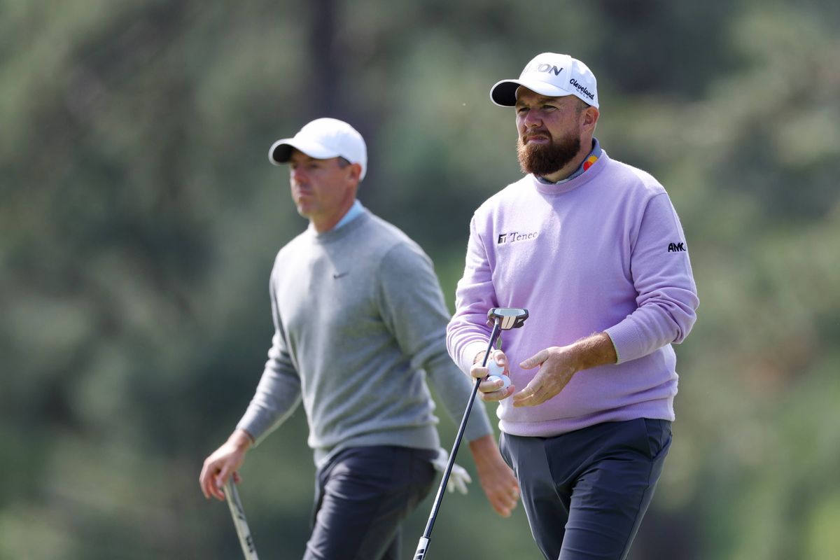 Shane Lowry of Ireland and Rory McIlroy of Northern Ireland walk on the third hole during a practice round prior to the 2025 Masters Tournament