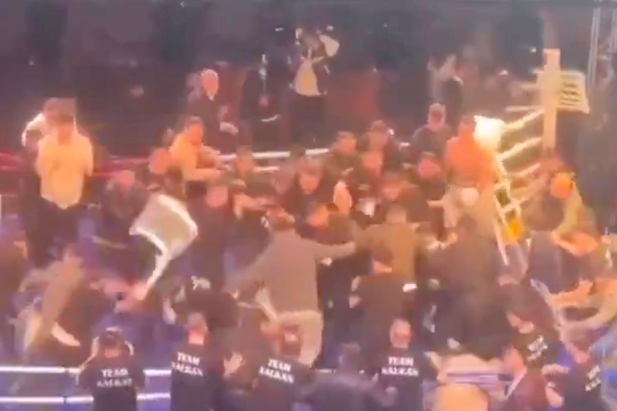 A brawl erupts during a boxing title fight