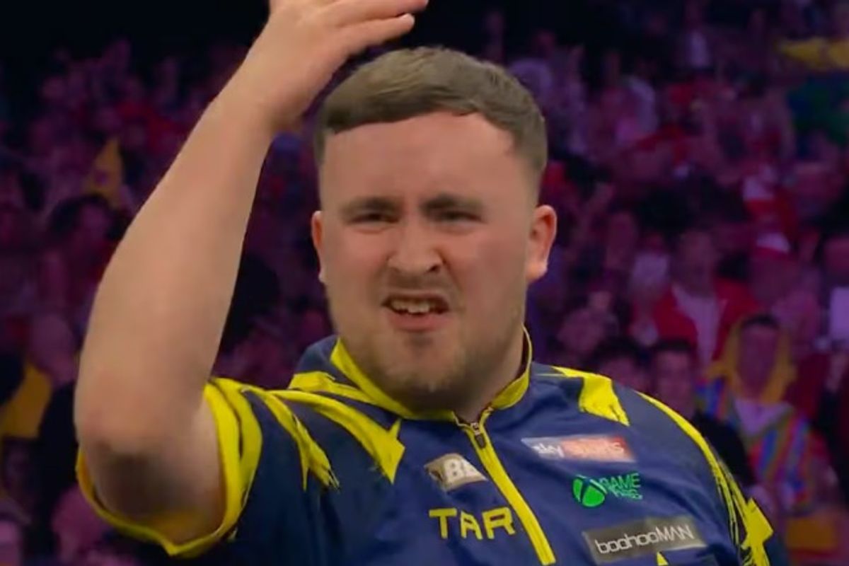 Luke Littler throws his arm in the air