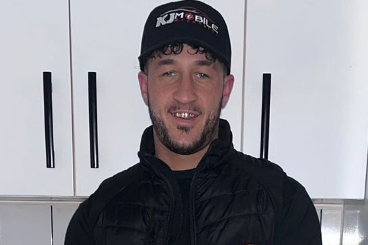 Mr Fletcher wearing a black cap, black T-shirt and black gilet and jeans