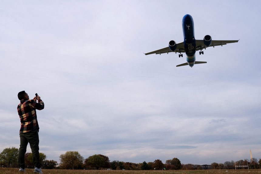A Jet Blue flight lands at Ronald Reagan Washington National Airport in Arlington, Virginia, on November 7, 2025.