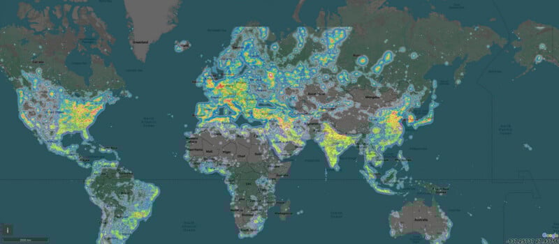 A world map showing light pollution levels; areas in yellow, orange, and red indicate high light pollution, mainly in Europe, the eastern US, India, and East Asia. Blue and green indicate lower light pollution.