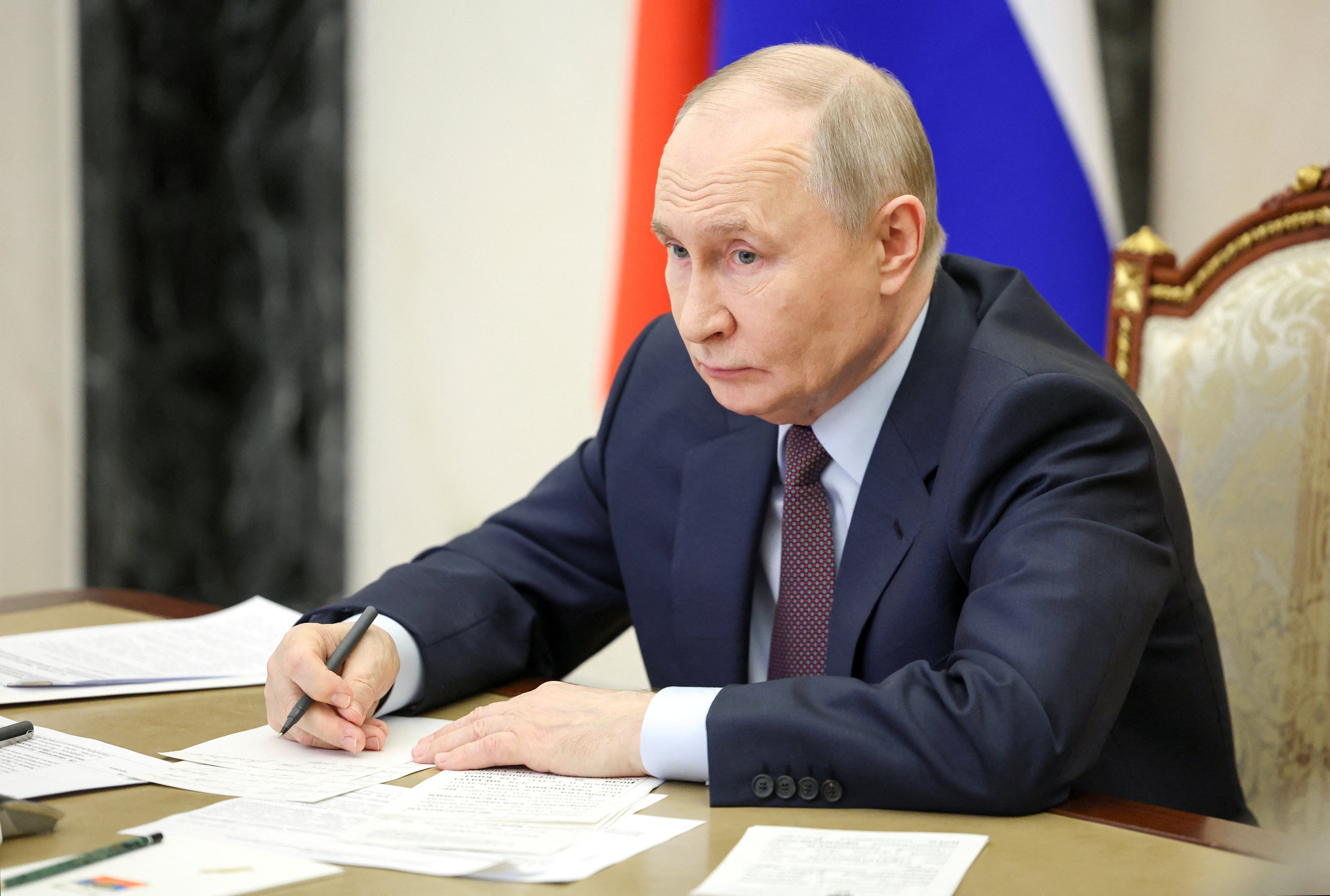 Russian president Vladimir Putin chairs a meeting with members of the government via video link at the Kremlin in Moscow