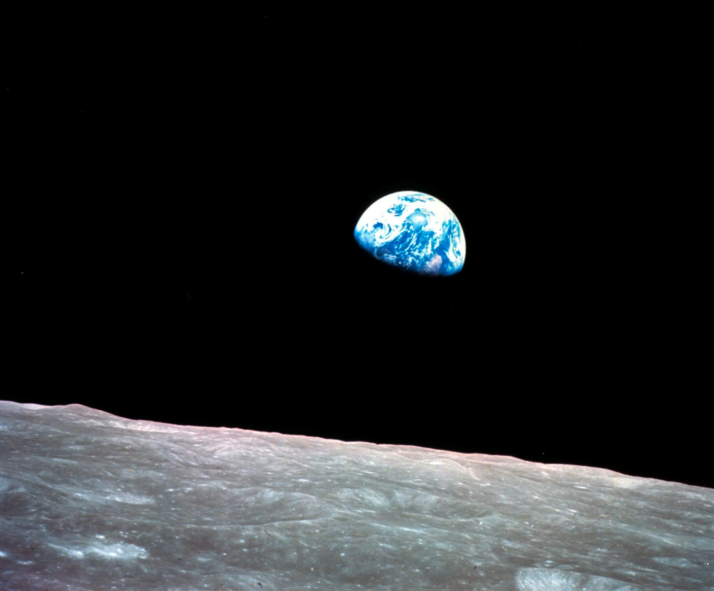 The iconic "Earthrise" photo shows the Earth appearing above the lunar horizon.