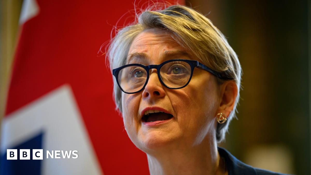 Foreign Secretary Yvette Cooper hosts a virtual meeting at the Foreign, Commonwealth and Development Office (FCDO) in Westminster. She wears black glasses, and a Union Jack is visible behind her.