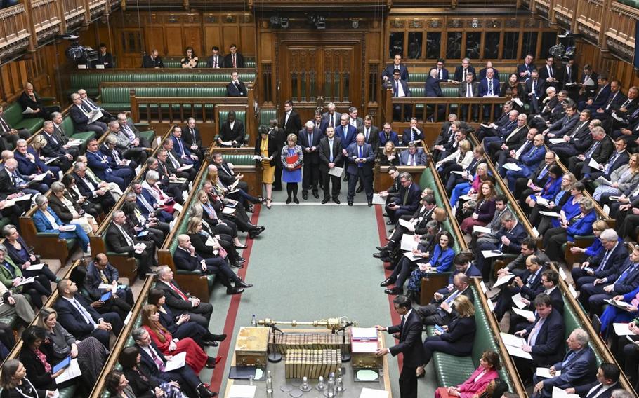 A group of parliamentarians watches British Prime Minister Keir Starmer address the legislative assembly.