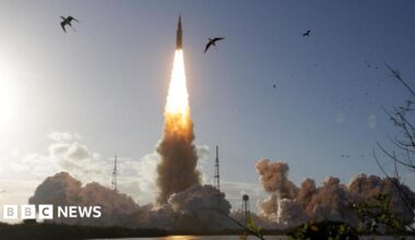Astronauts pointing at a screen inside the Orion spacecraft