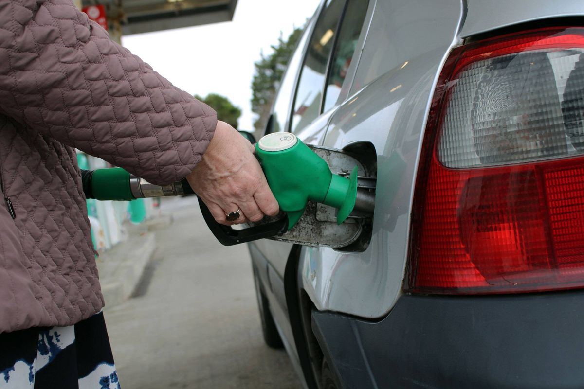 Close-Up of Hand Holding Fuel Pump Nozzle Refueling Car at Petrol Station - Gasoline, Energy and Transportation