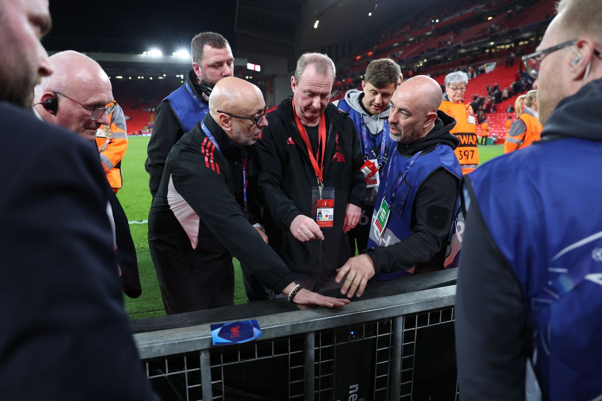 Ground staff and members of Liverpool investigate the board on which Noa Lang of Galatasaray sustained an injury to his thumb during the UEFA Champions League round of 16 second leg at Anfield on March 18 2026