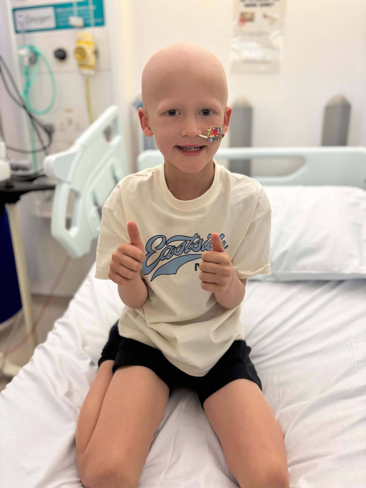 Tommy in hospital giving a thumbs up