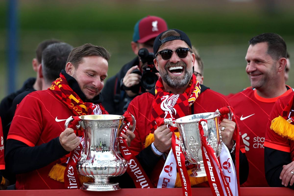 Pep Lijnders, Assistant Manager and Jurgen Klopp, Manager of Liverpool pose with the FA Cup and the Carabao Cup Trophy in 2022