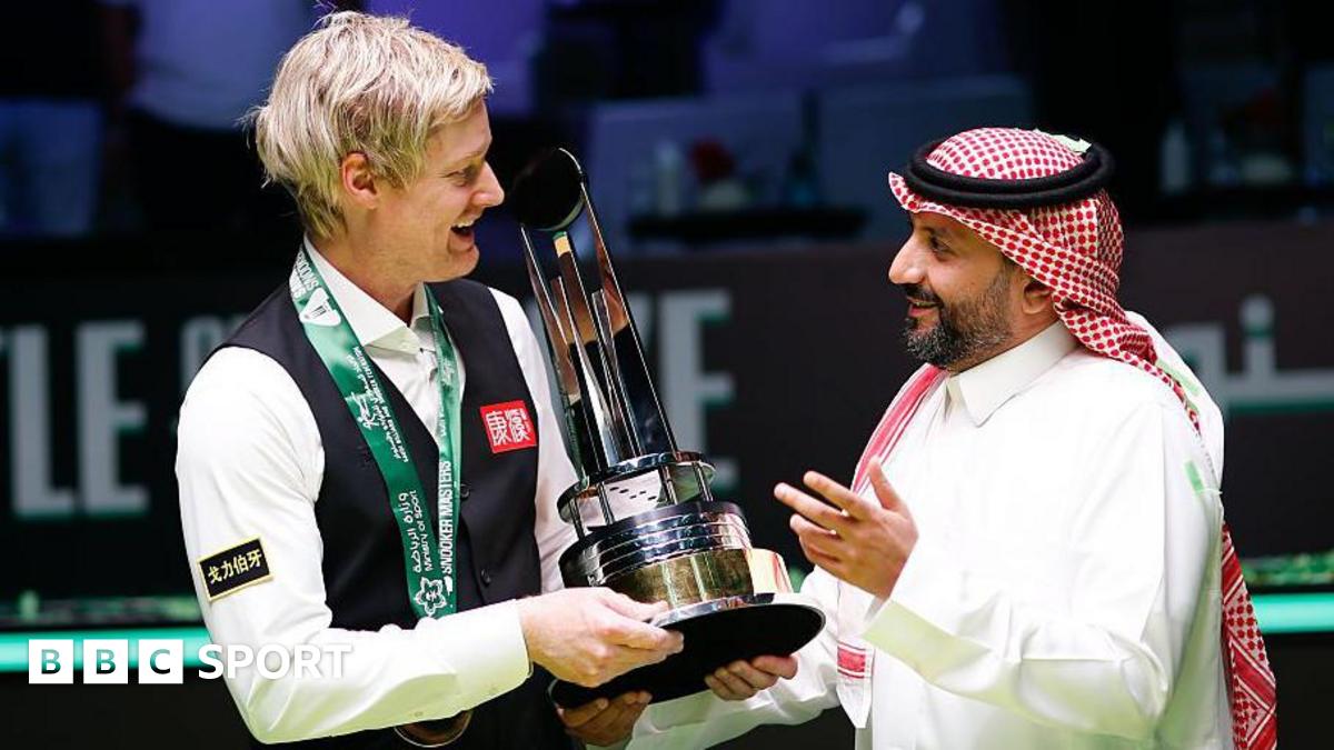 Neil Robertson being presented with the Saudi Arabia Snooker Masters trophy
