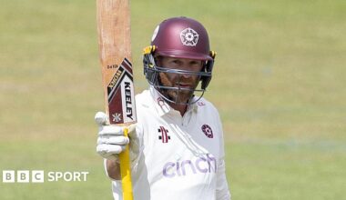 Luke Procter raises his bat during an innings for Northamptonshire