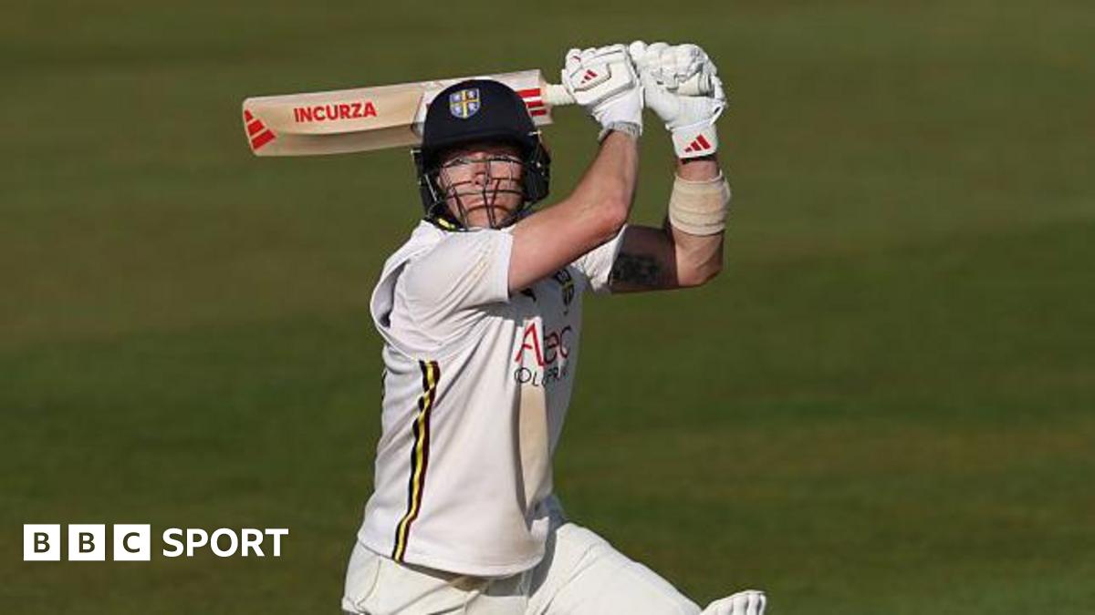 Right-hander Matthew Potts with the bat above his head as he plays a shot through the offside in evening sunshine in Durham