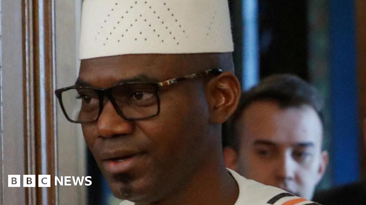 Malian Defence Minister Sadio Camara, wearing traditional dress, is pictured with Russian Foreign Minister Sergey Lavrov (C) and Malian Foreign Minister Abdoulaye Diop (R), both wearing suits and ties at a meeting in Moscow.