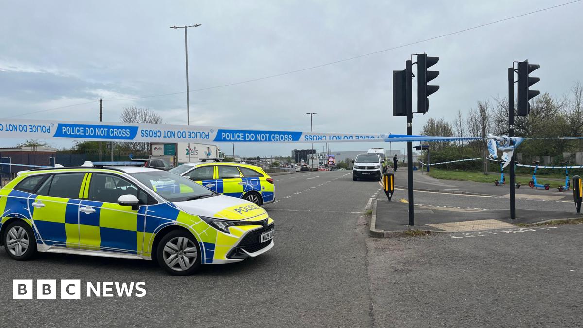 Two police cars and a police cordon on the intersection of a main road in Filton, north Bristol.