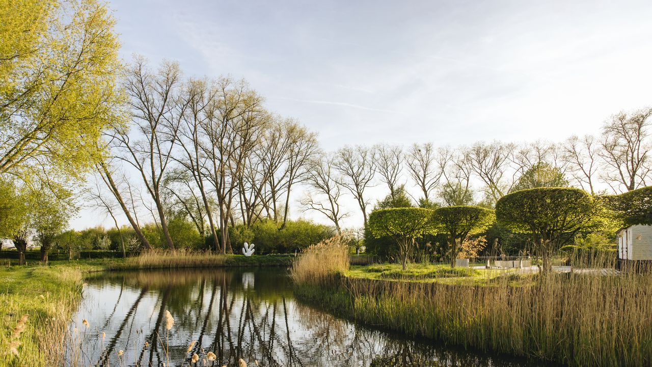 A fortified farmstead near Bruges whose free-flowing garden is shaped by art