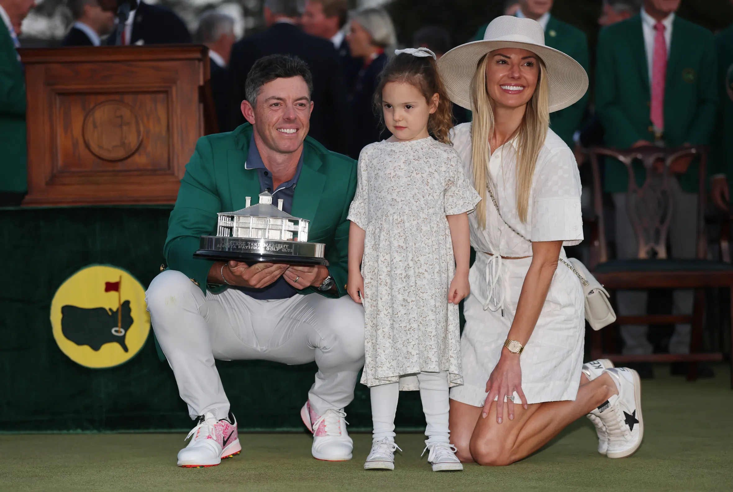 Rory McIlroy, his daughter Poppy, and wife Erica Stoll pose with the Masters trophy.