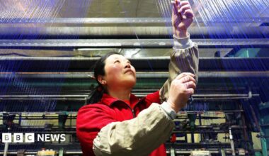 Women workers on a production line in a factory in Fuyang, China adjust circuit breakers while wearing blue overalls, pictured on 4 March.