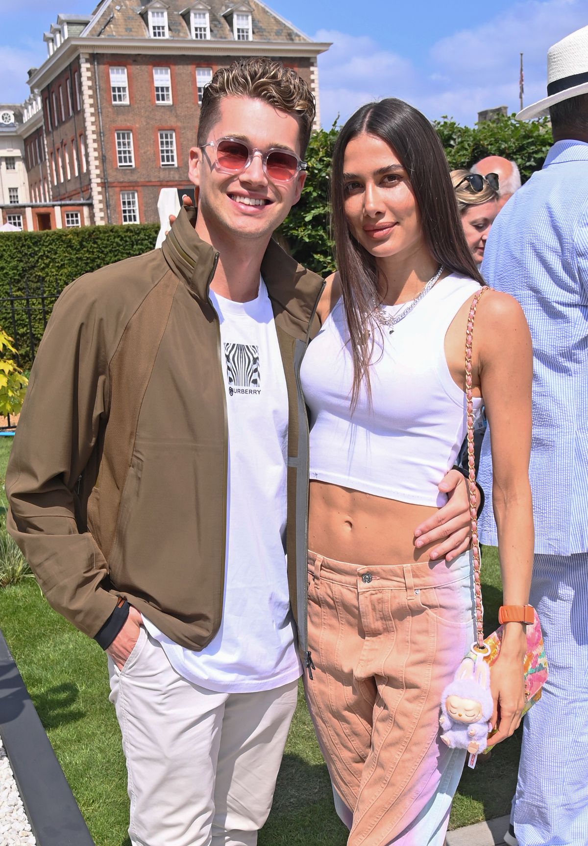  AJ Pritchard and Zara Zoffany smiling outdoors at The RHS Chelsea Flower Show 2025 