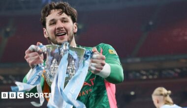 James Trafford holds the Carabao Cup trophy