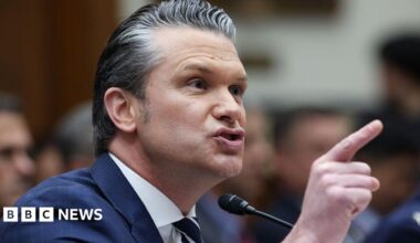 A close photo of Pete Hegseth pointing his finger and speaking into a mic at a congressional hearing