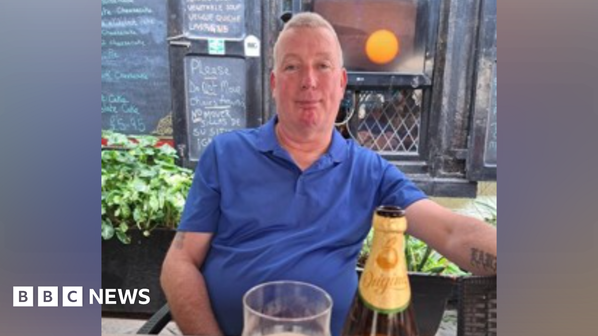 Man sitting in pub wearing blue shirt
