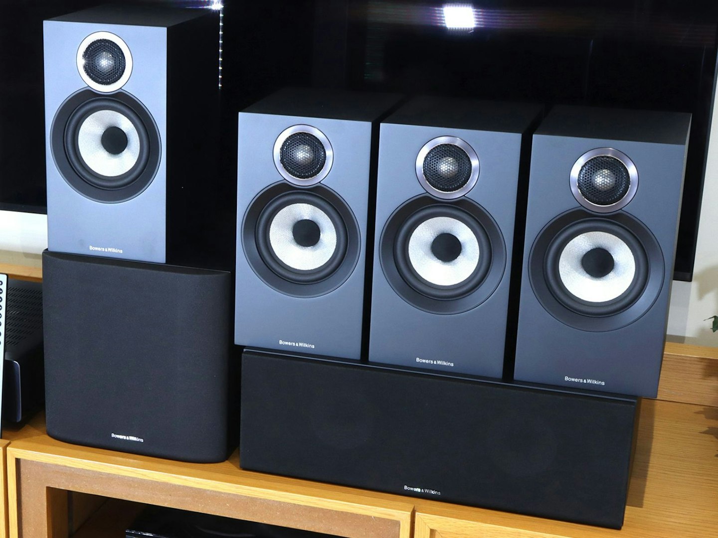 B&W 607 speakers on a unit in a living room