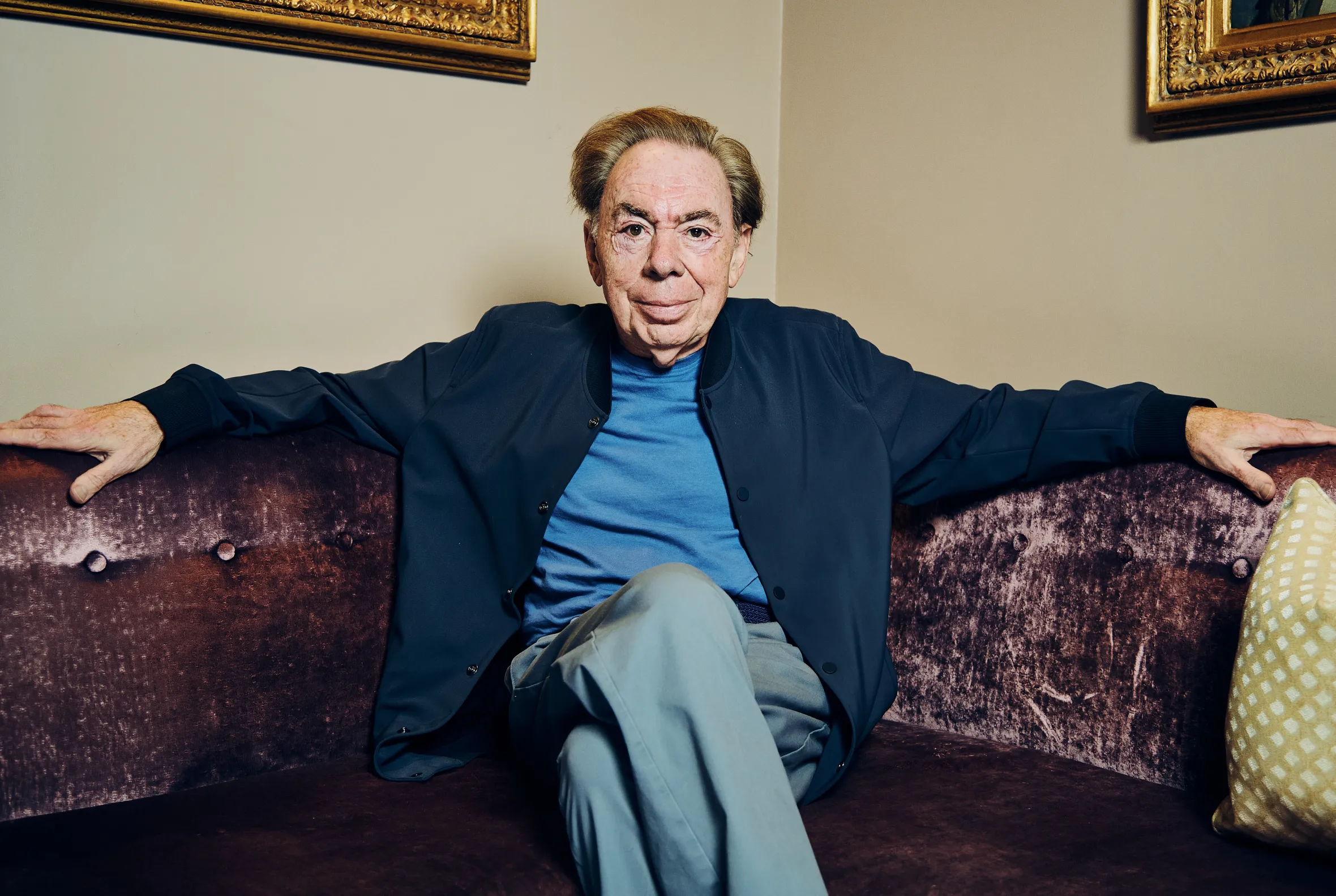 Andrew Lloyd Webber sitting on a couch.