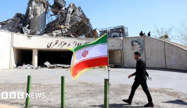 An Iranian official walks next to the damaged Azadi sports complex in Tehran, Iran (3 April 2026)