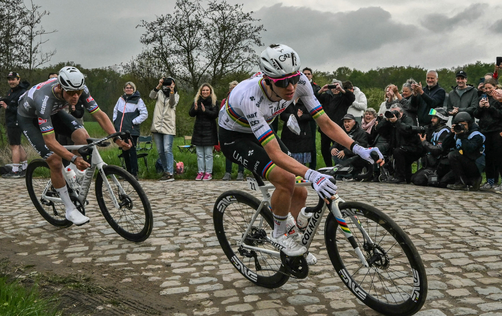 Alpecin-Deceuninck's Dutch rider Mathieu van der Poel (L) and UAE Team Emirates Slovenian rider Tadej Pogacar cycle in a breakaway in a paved area during the 122nd edition of the Paris-Roubaix