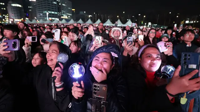 Fans cheer during the group's comeback concert
