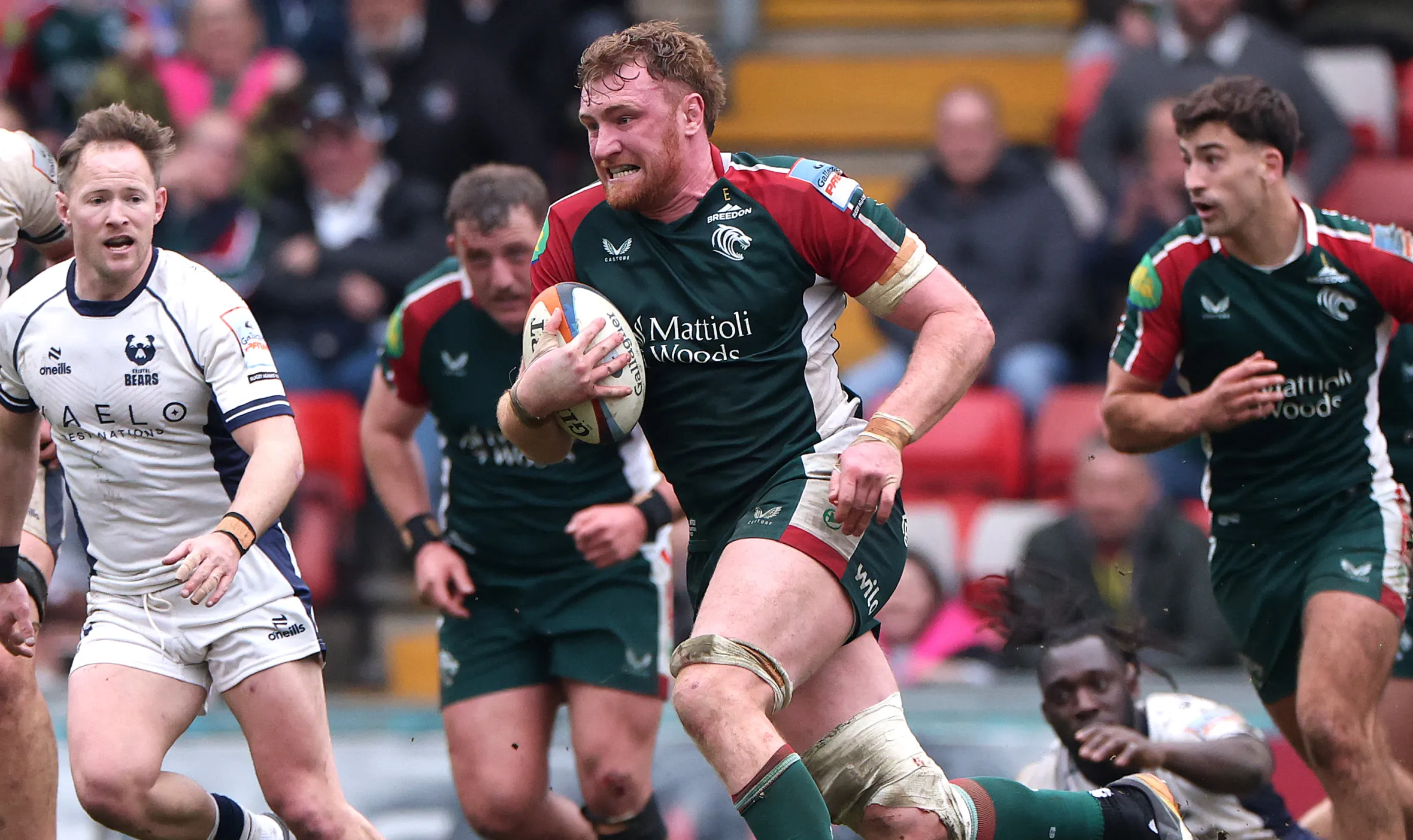 Ollie Chessum of Leicester Tigers charges upfield with the ball during a rugby match against Bristol Bears.