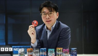 CEO of condom manufacturer Karex, Goh Miah Kiat, poses with condoms manufactured by the company in Malaysia