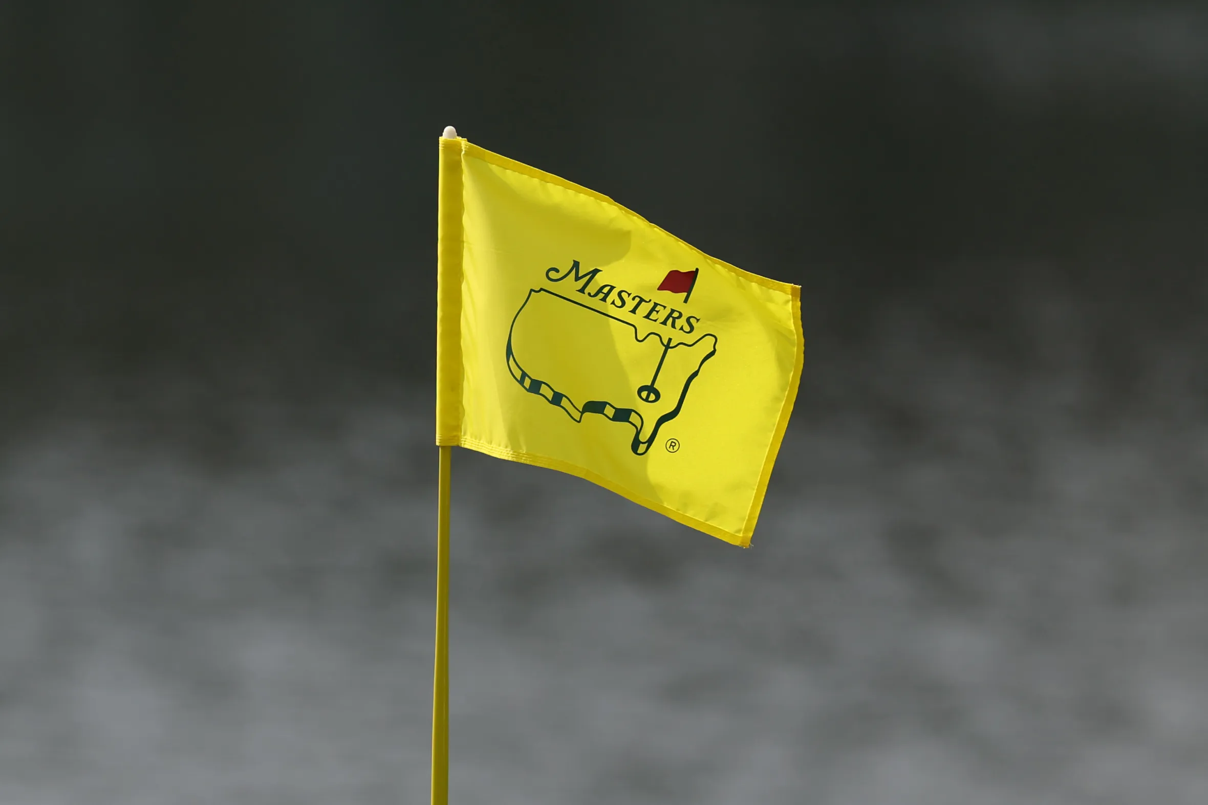 A yellow Masters Tournament pin flag on the 16th hole green.