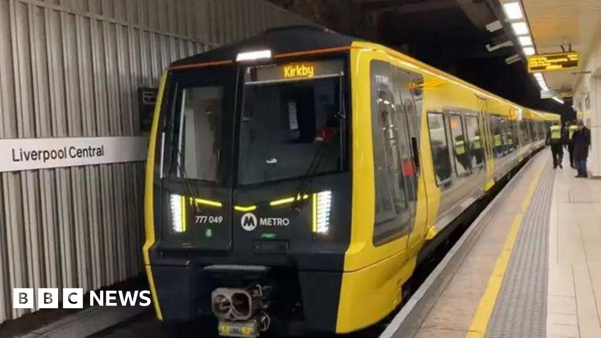A yellow train car at Liverpool Central station platform