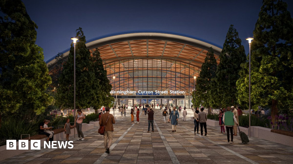 An artist's impression of the new Curzon street station, showing people outside a huge arch entrance with "Birmingham Curzon Street Station" in bold white signage.