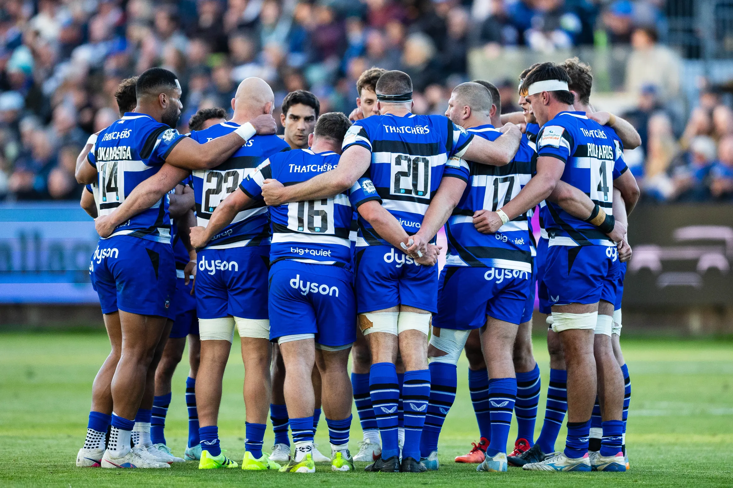 Bath Rugby players huddle during a break in play.
