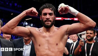 Hamzah Sheeraz flexes his muscles as he celebrates in the ring