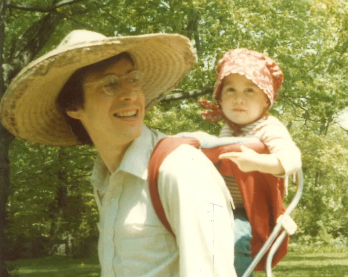 Psychiatrist Robert Goodman carrying his daughter Rosa in a backpack carrier.