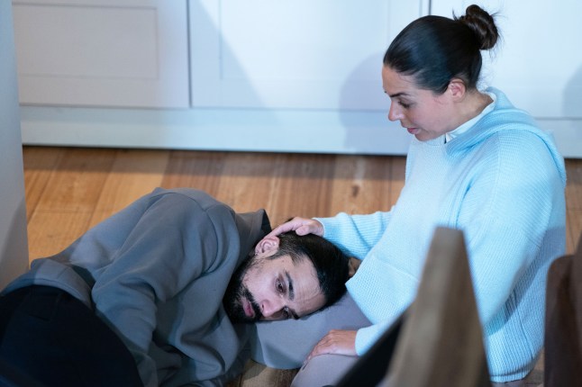 Priya cradling a sleeping Ravi